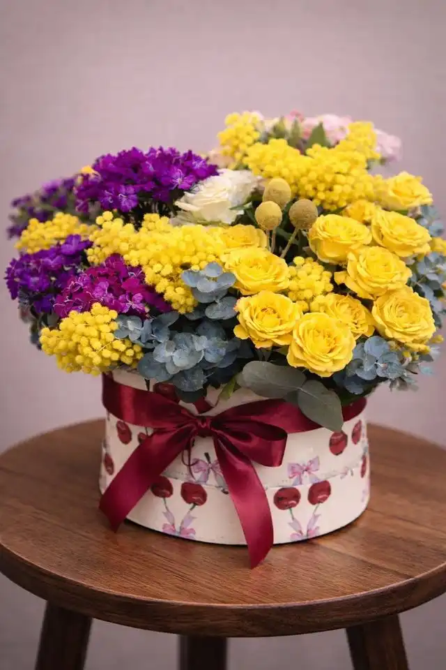 Cappelliera con mimosa, rose gialle e fiori viola